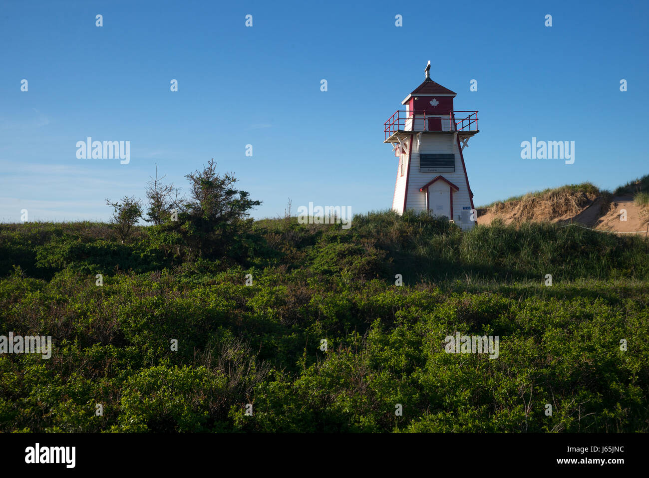 Lighthouse at coast, North Shore, Prince Edward Island National Park