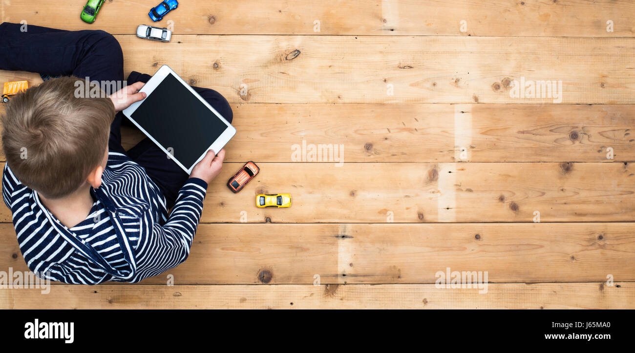 top view header of boy playing with tablet pc Stock Photo