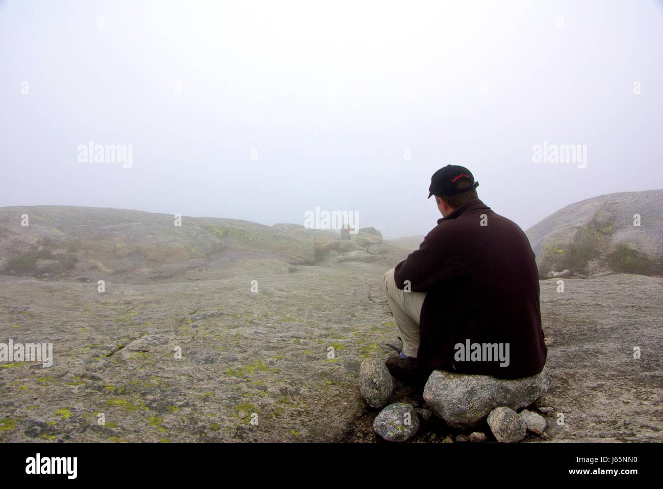 fog hopeless put sitting sit alone lonely grey gray man clouds wait waiting  Stock Photo - Alamy