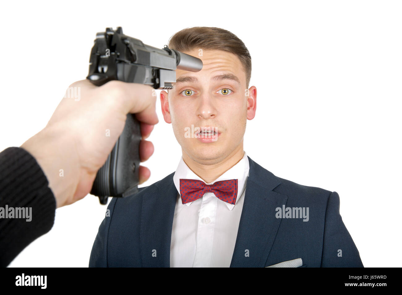 Pointing handgun on a business man's head Stock Photo