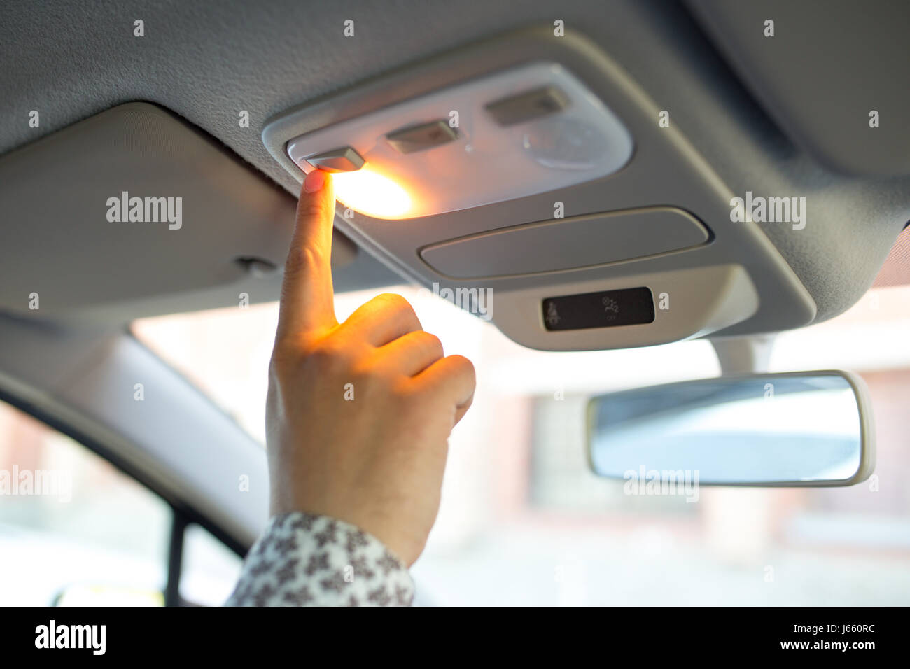 Man turning on the light in the car in his car, close-up Stock Photo