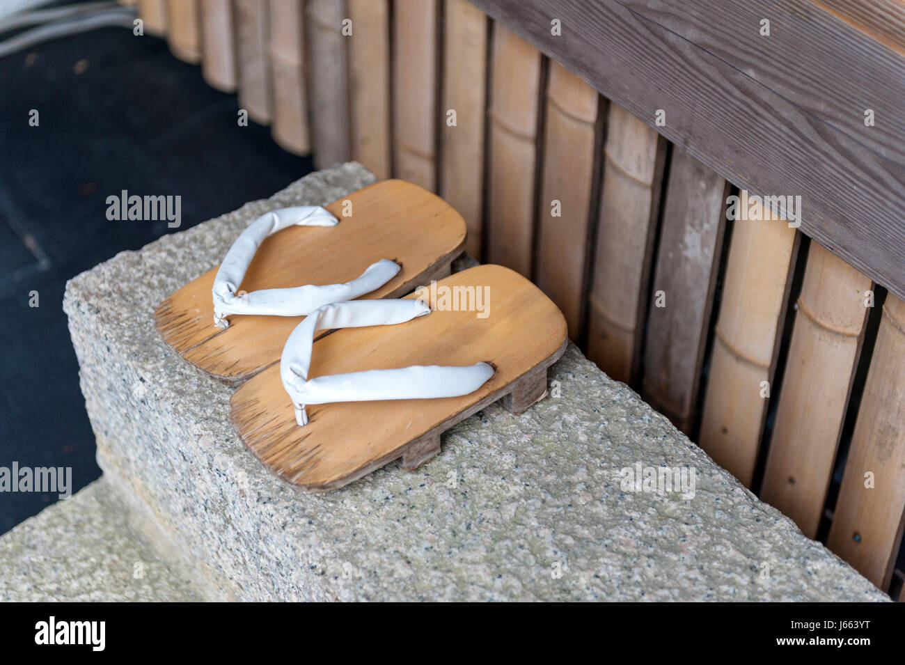 Geta or traditional Japanese footwear, a kind of flip-flops or sandal with an elevated wooden base held onto the foot with a fabric thong strap Stock Photo