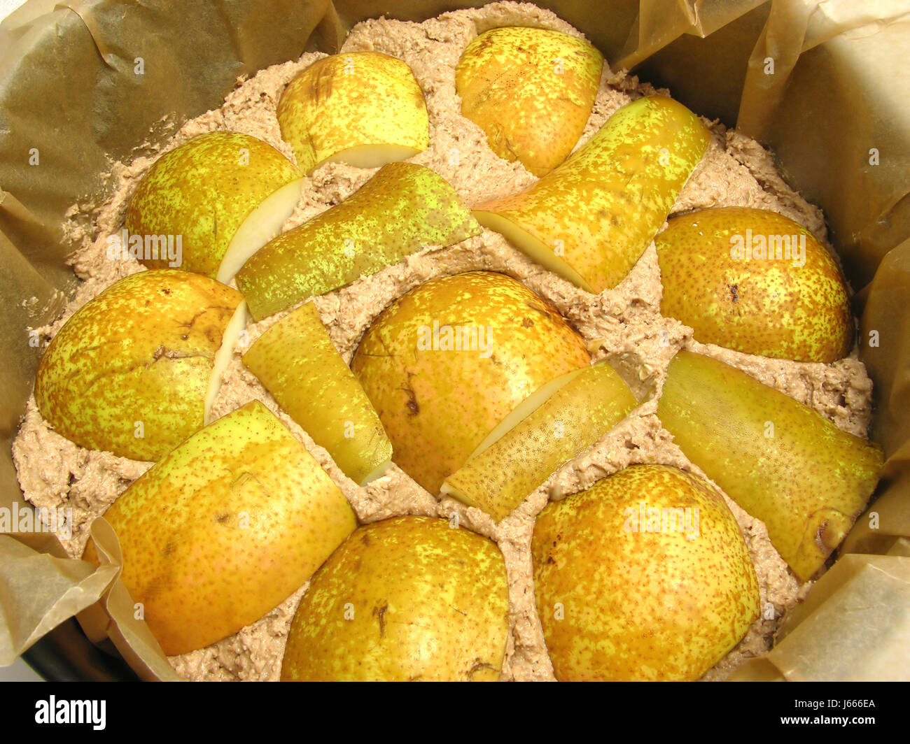 dough of wholemeal cake with pears in a baking dish Stock Photo