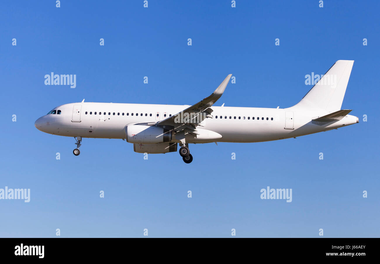 Airplane without livery approaching to the airport. Stock Photo