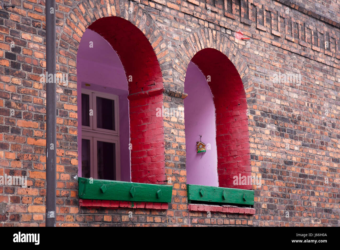 Katowice, Poland - February 10, 2015: Wall and windows of a red brick house in  Nikiszowiec,  Silesia in Poland. Historic residential Buildings. Minin Stock Photo