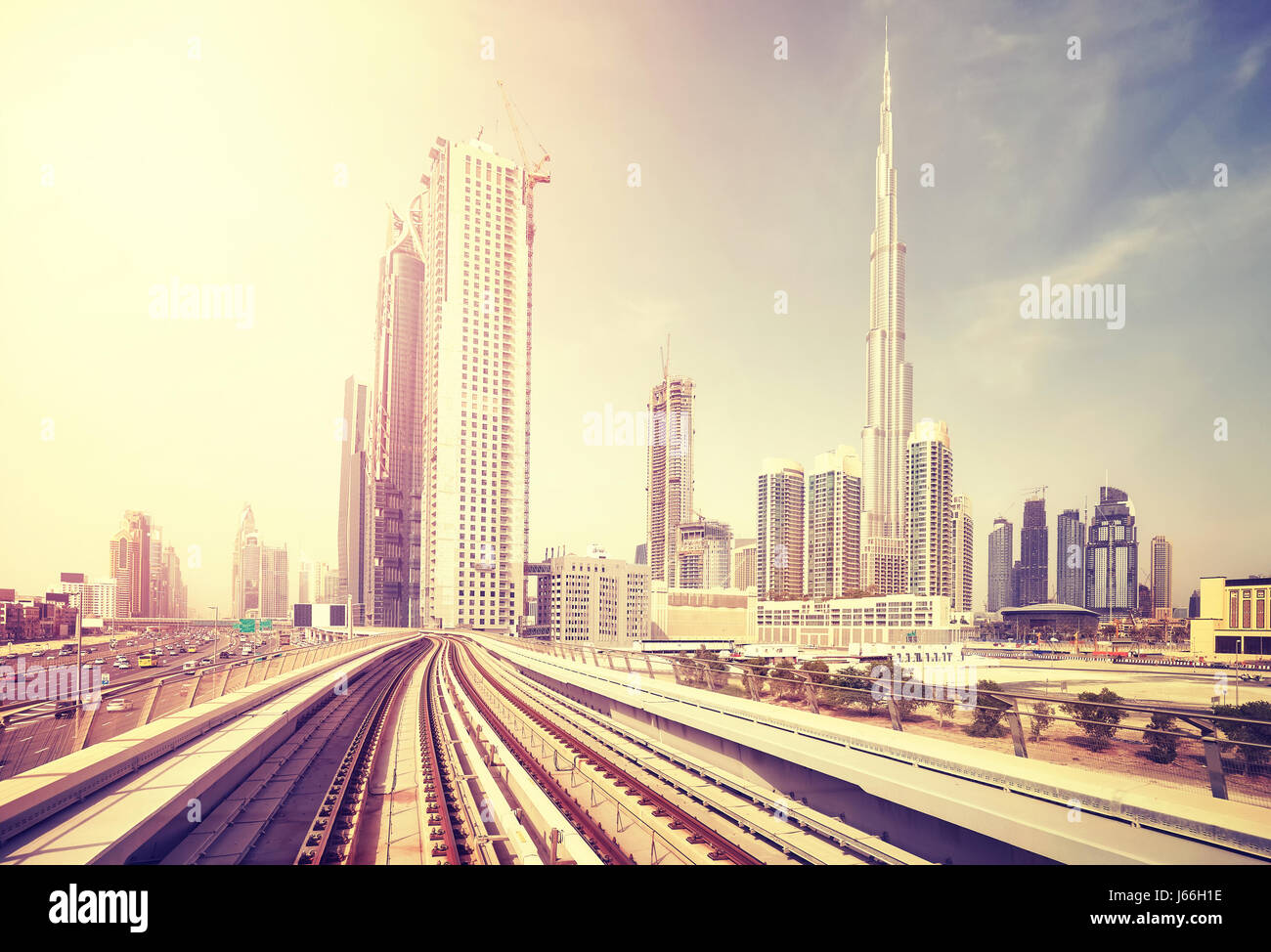 Dubai modern downtown seen from metro train, color toning applied, United Arab Emirates. Stock Photo