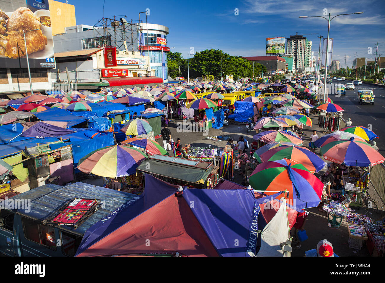 Hundreds of colorful umbrellas shade vendors in the huge outdoor marketplace in Baclaran, Manila, Luzon Island, Philippines. Stock Photo