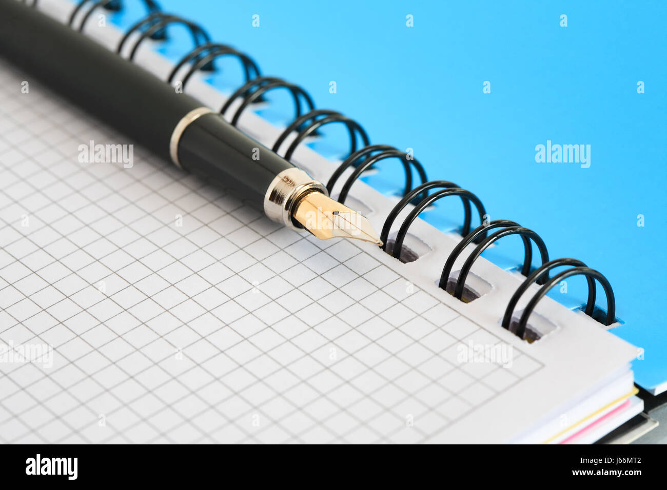 Closeup of blank open spiral notebook and fountain pen. Good background Stock Photo