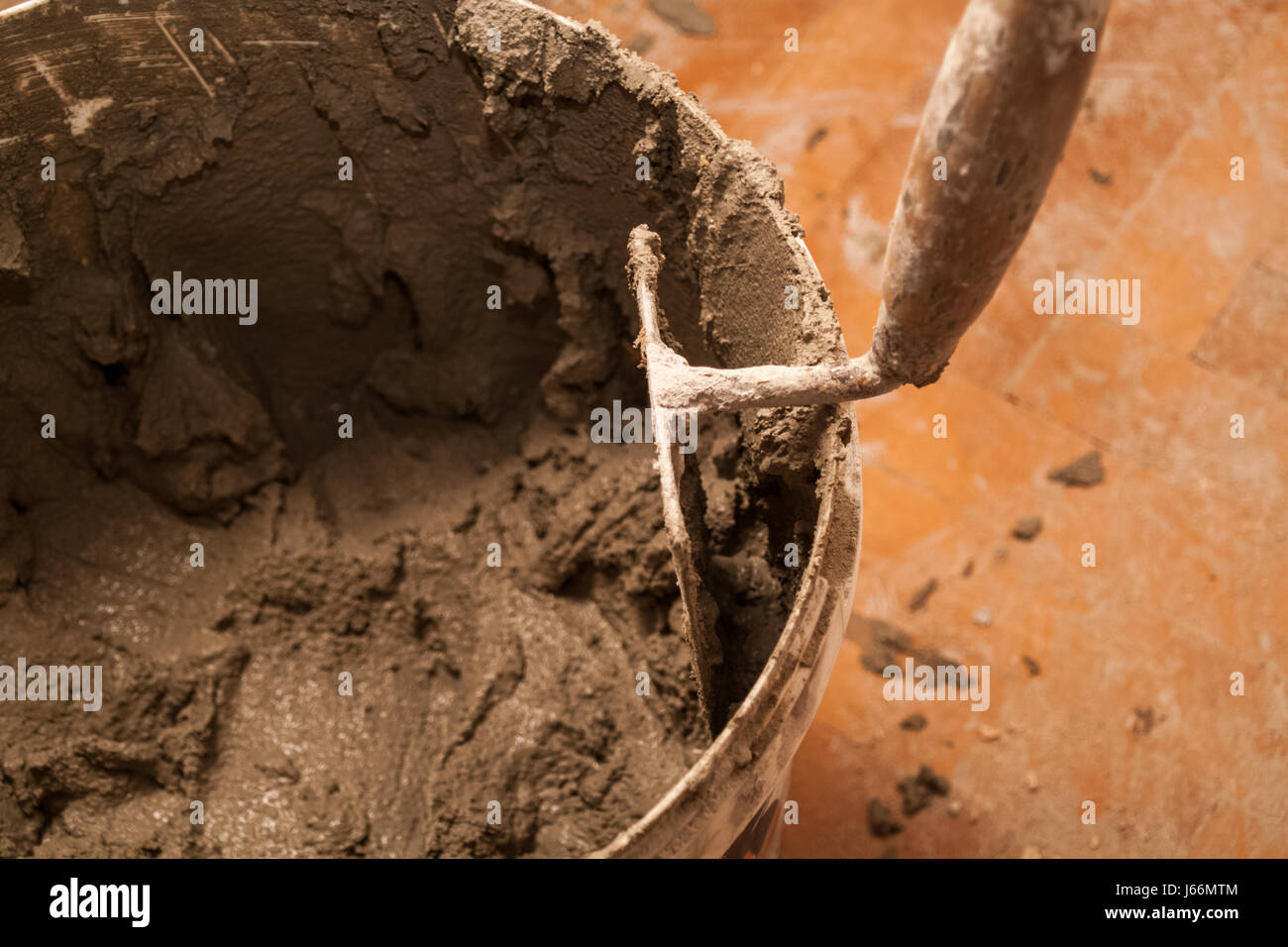 Flat renovation, master mixed the mortar in a plastic bucket and trowel