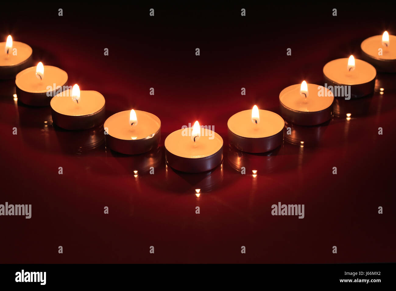 Set of lighting candles in a row on dark background Stock Photo - Alamy