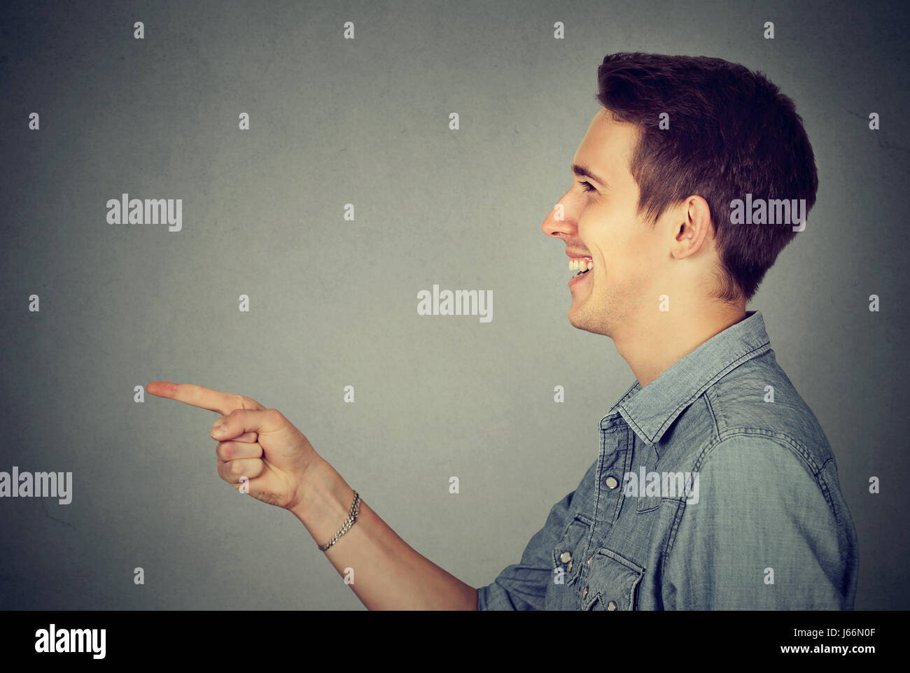Side profile of a laughing young man Stock Photo