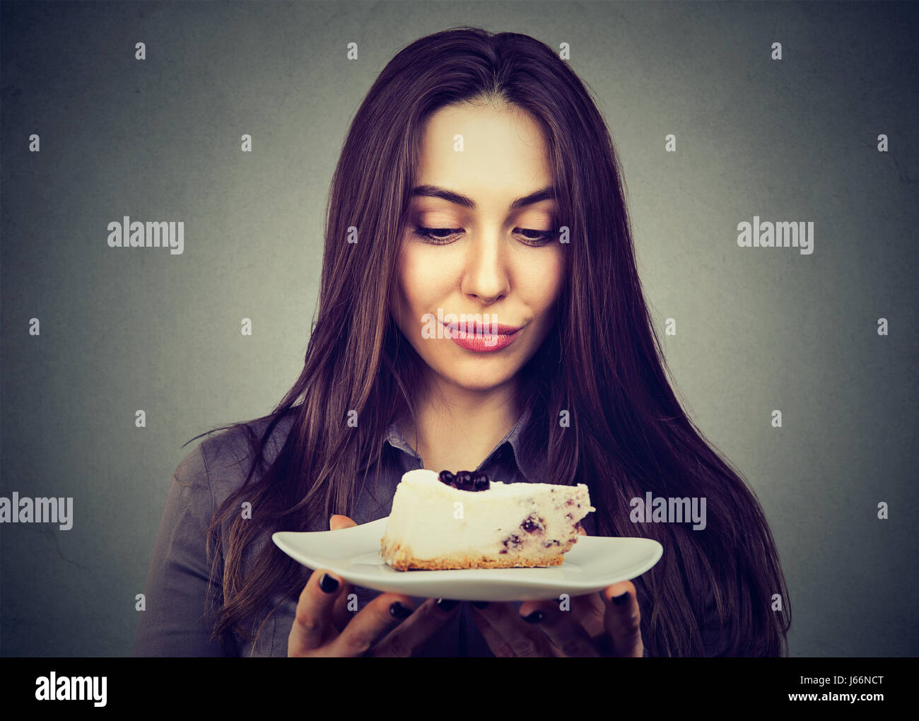 woman craving cake dessert, eager to eat Stock Photo