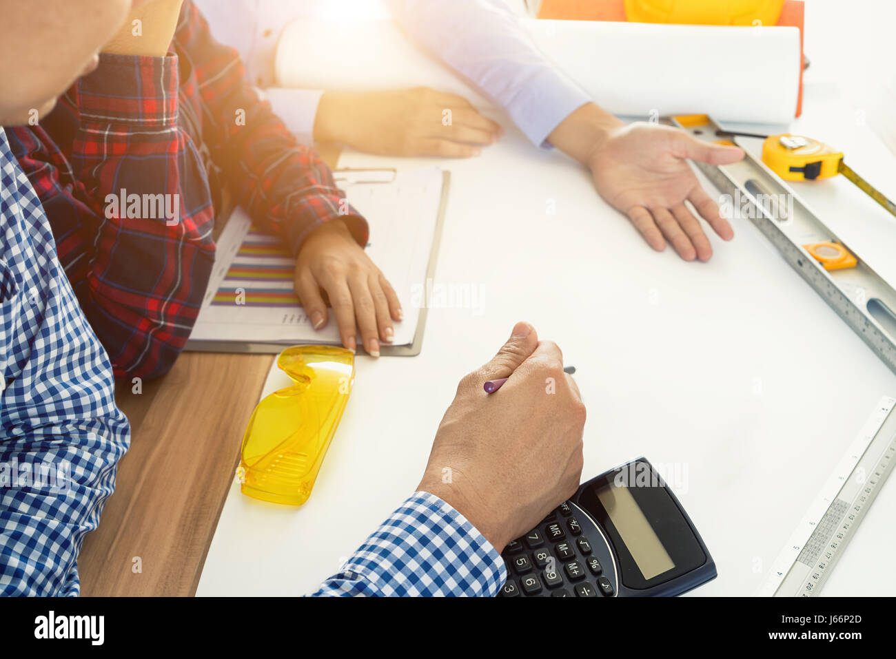 Image of engineer meeting for architectural project. working with partner and engineering tools on workplace. Engineer, discussing, architect concept. Stock Photo