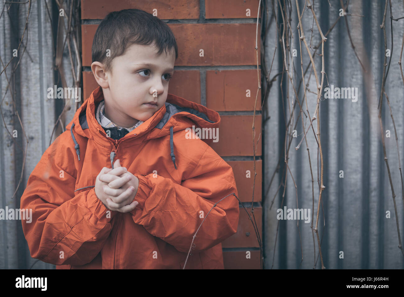 Portrait of sad little boy outdoors at the day time. Concept of dreary ...