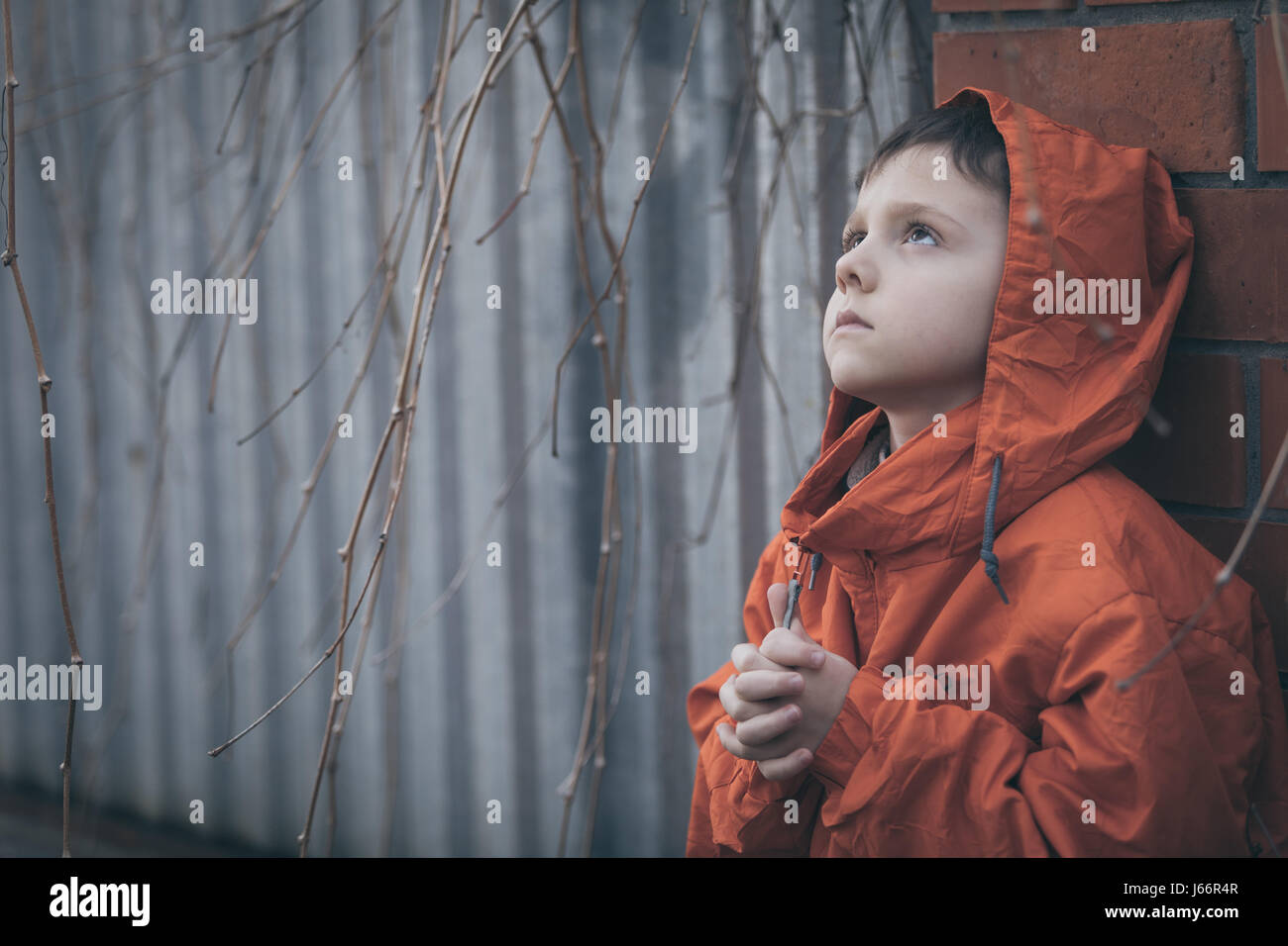 Portrait of sad little boy outdoors at the day time. Concept of dreary ...