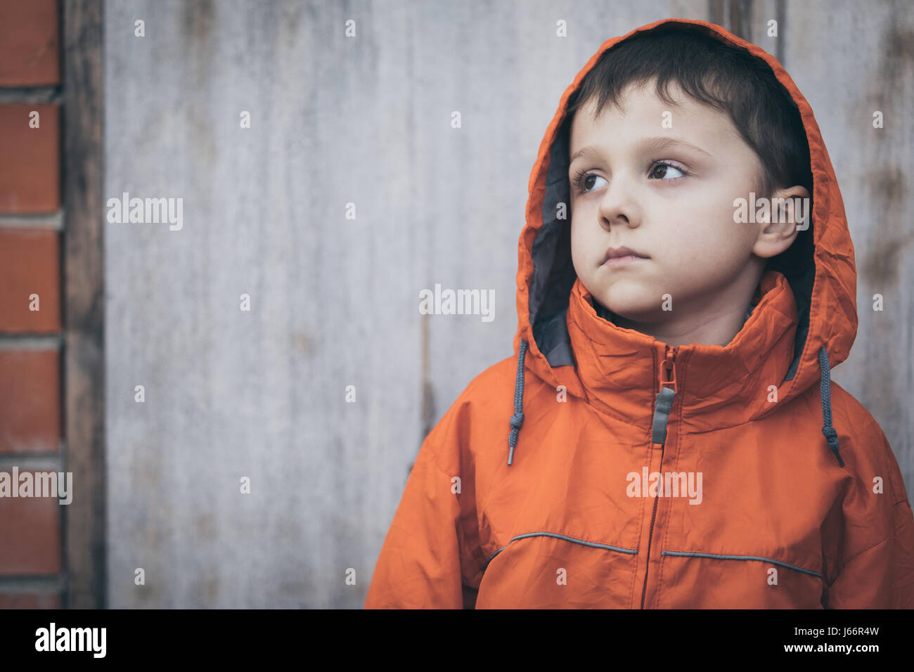 Portrait of sad little boy outdoors at the day time. Concept of dreary ...