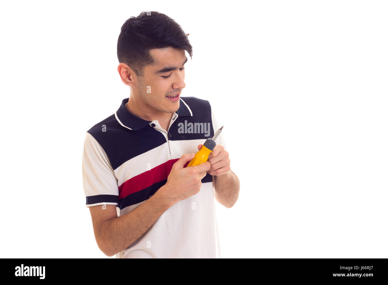 Young man holding a screwdriver Stock Photo