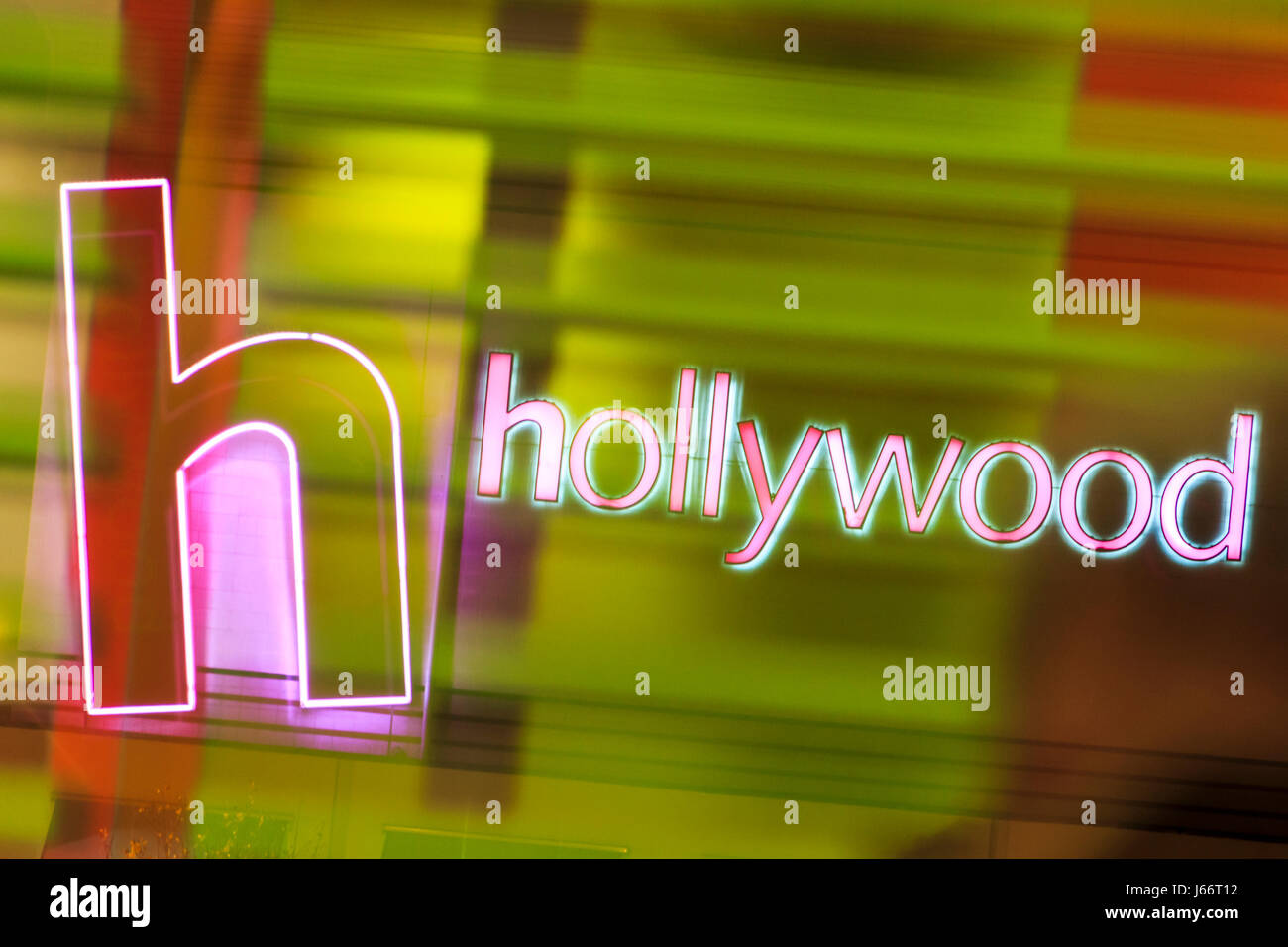 Pink neon Hollywood sign reflected in a green-lit glass window Stock Photo