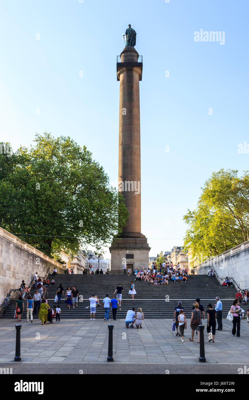 Sightseers and tourists on the steps of Duke of York Column, St. James's, London, UK Stock Photo