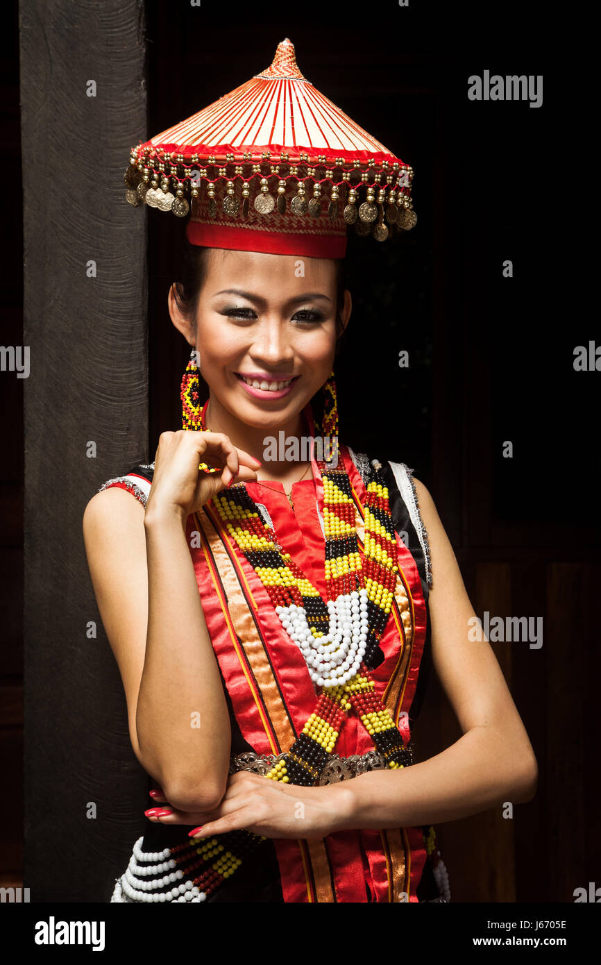 Portrait of a tribal woman. Tribal headdress and colorful ethnic costume of beautiful bidayu ethnic minority woman posing for the camera in finery Stock Photo