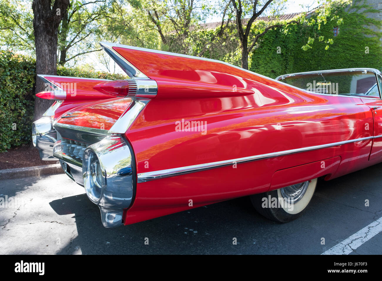Detail photograph of the tail fins on a vintage red Cadillac convertible, circa 1950's in a car park in Napa county California. Stock Photo