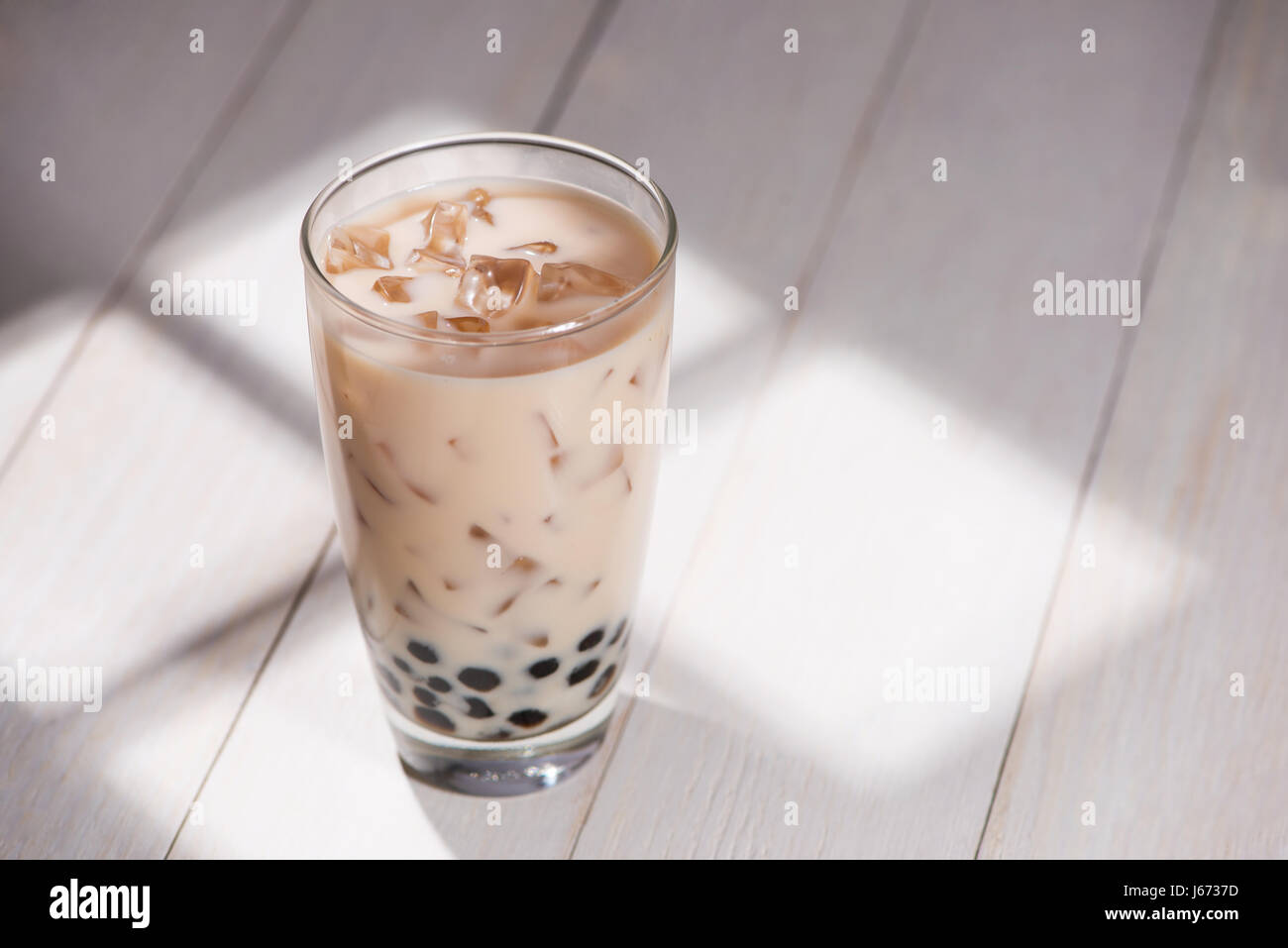 Boba / Bubble tea. Homemade Milk Tea with Pearls on wooden table. Stock Photo