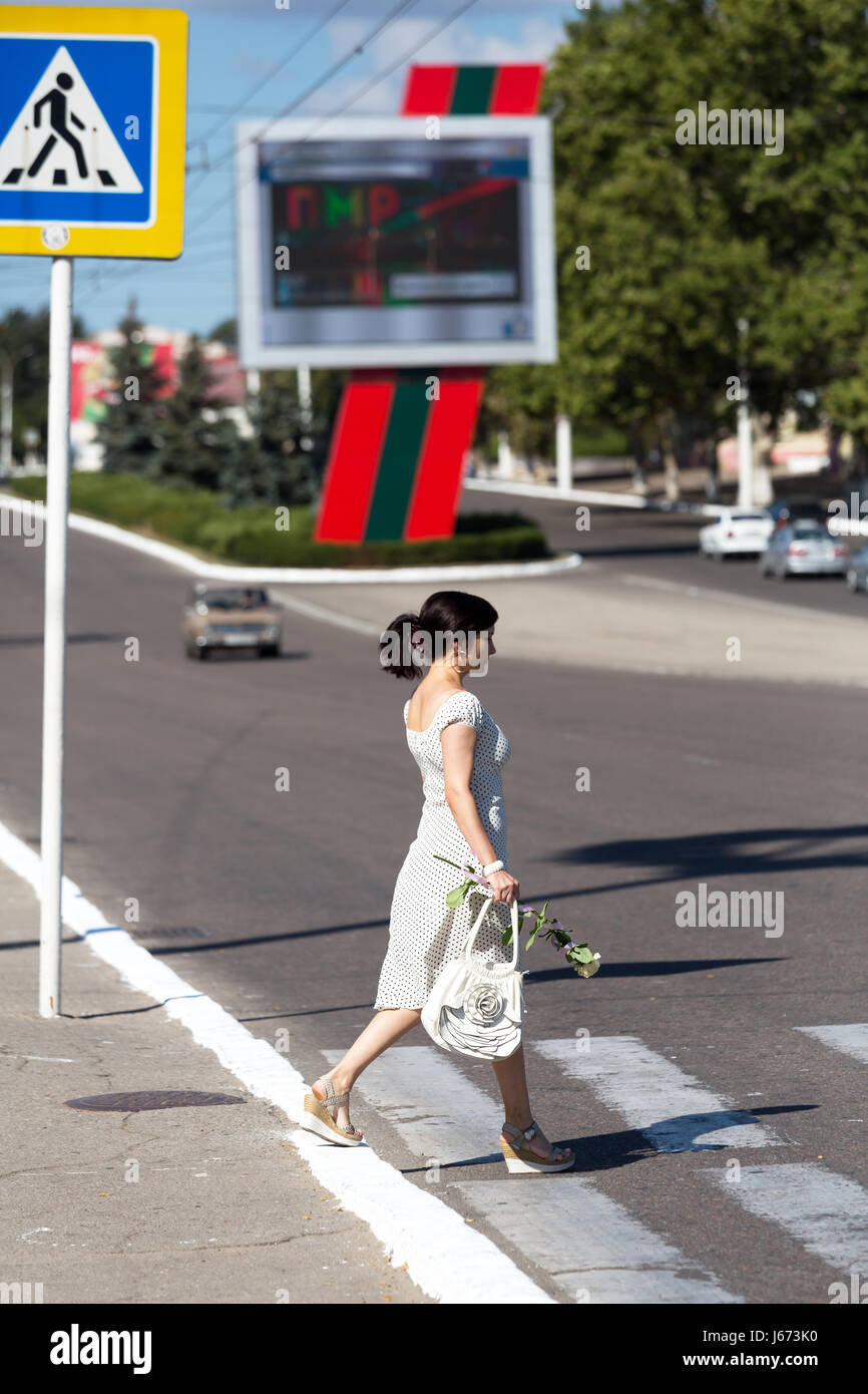 Tiraspol, Republic of Moldova, a woman crosses the main street Stock Photo