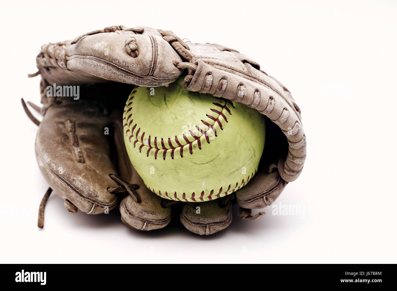 Softball in glove on white background Stock Photo Alamy