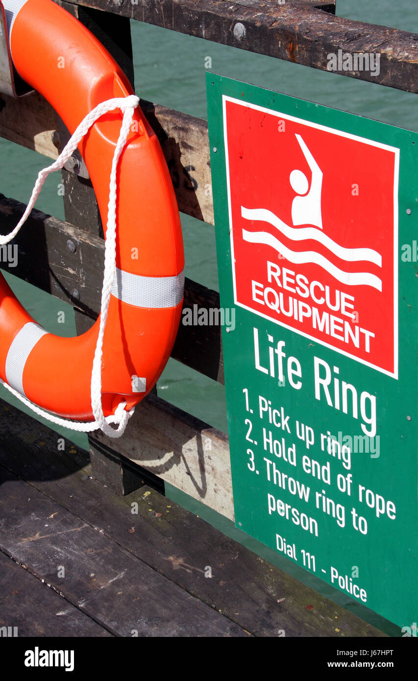 green rescue lifebelt orange live-saving equipment shield green wood bridge Stock Photo