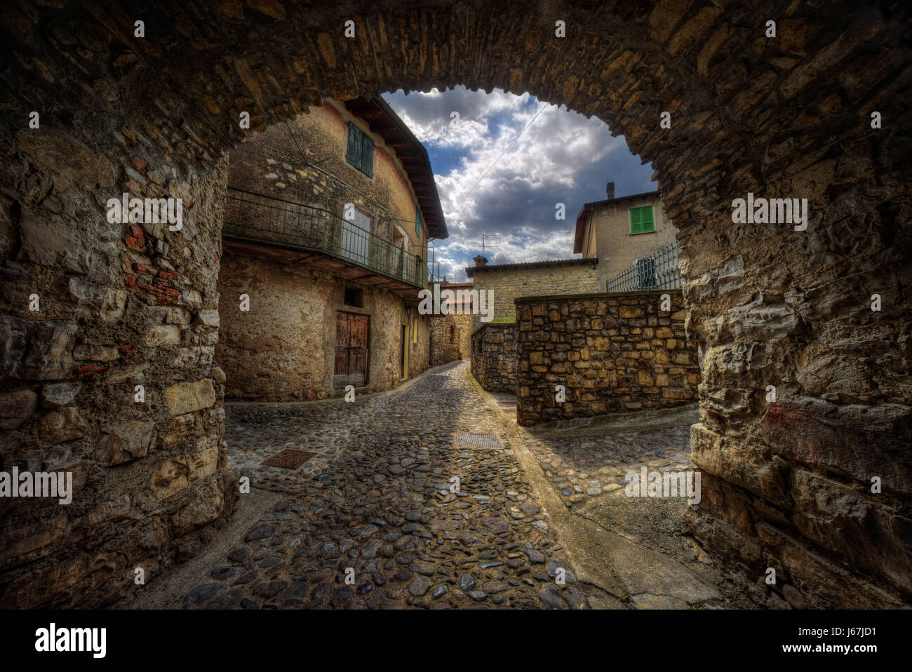 Arche on narrow stone street in Masse village on Monte Isola at Iseo Lake, Italy Stock Photo