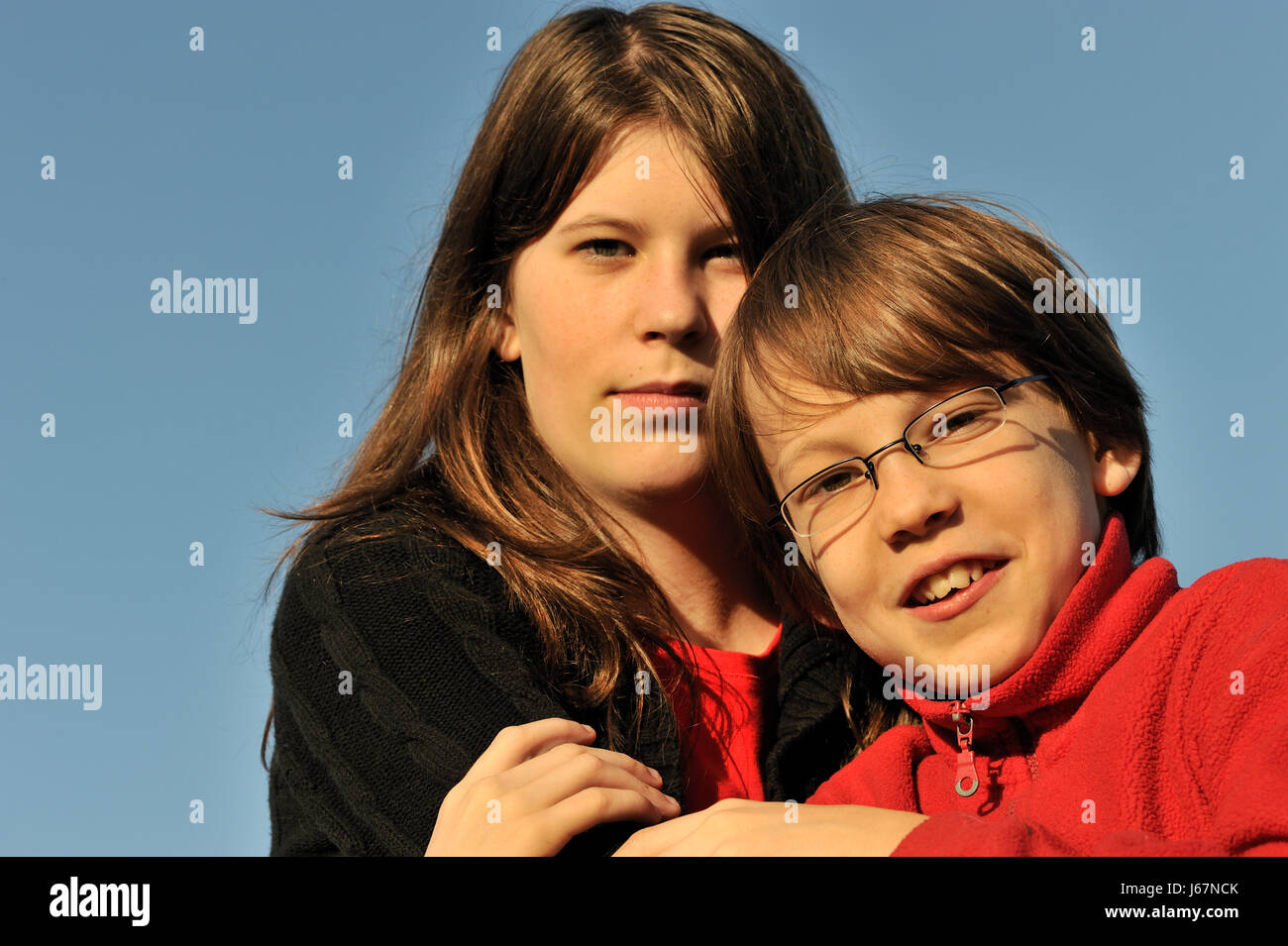 brother and sister,arm in arm Stock Photo