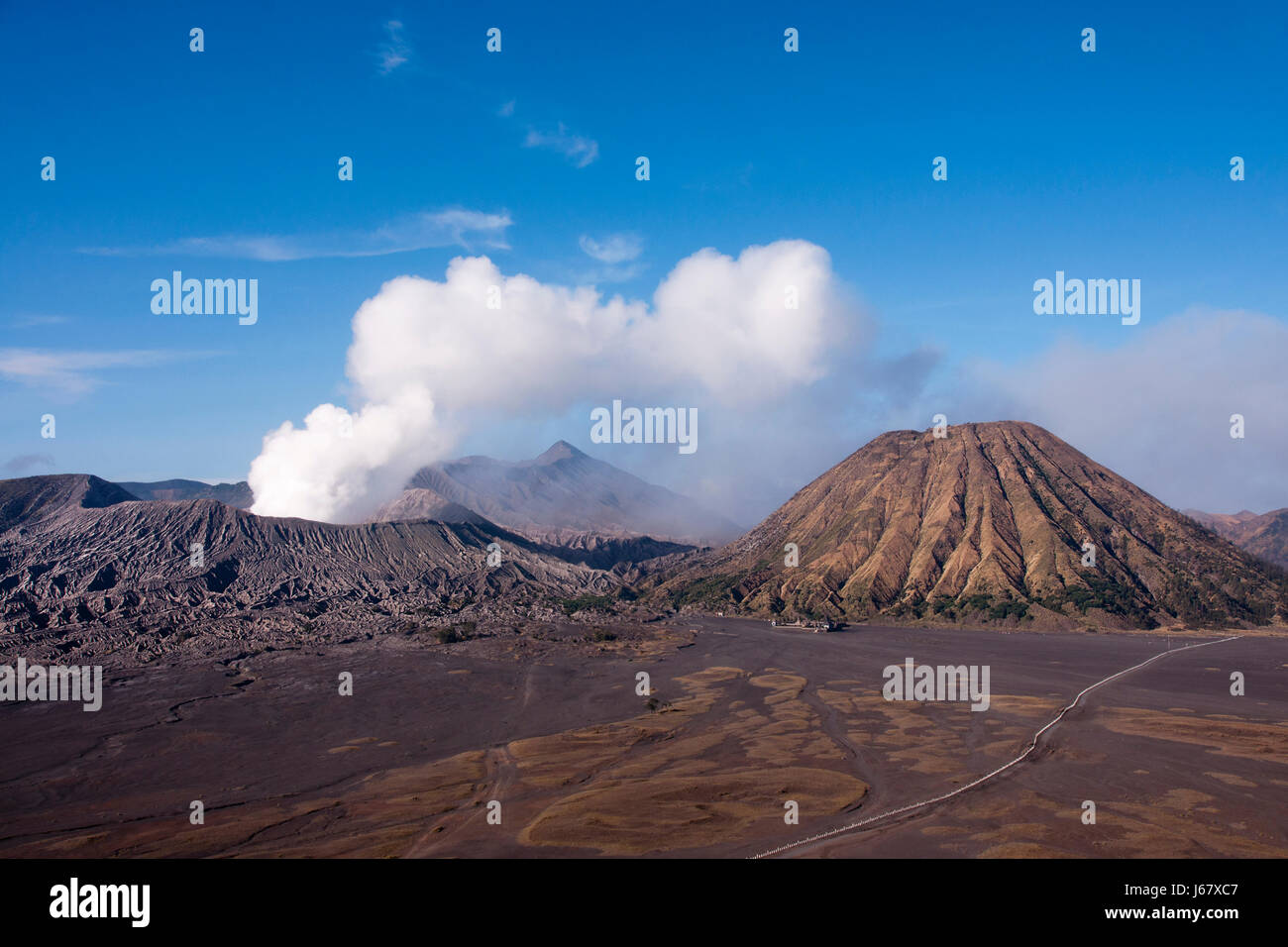Mount Bromo, an active volcano with clear blue sky at the Tengger Semeru National Park in East Java, Indonesia. Stock Photo