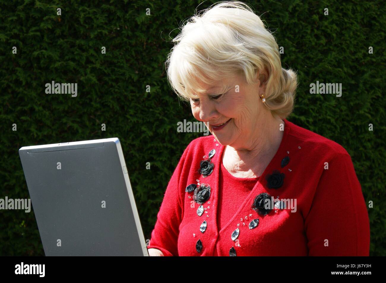 woman in garden with laptop Stock Photo - Alamy