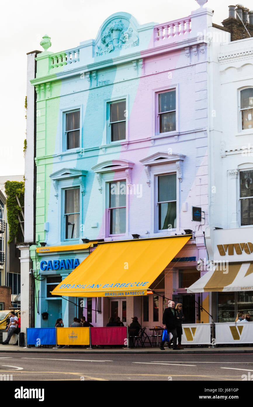 Multicoloured facade and orange awning of 'Cabana', a Brazilian Barbecue Restaurant, Upper Street, Islington, London, UK Stock Photo