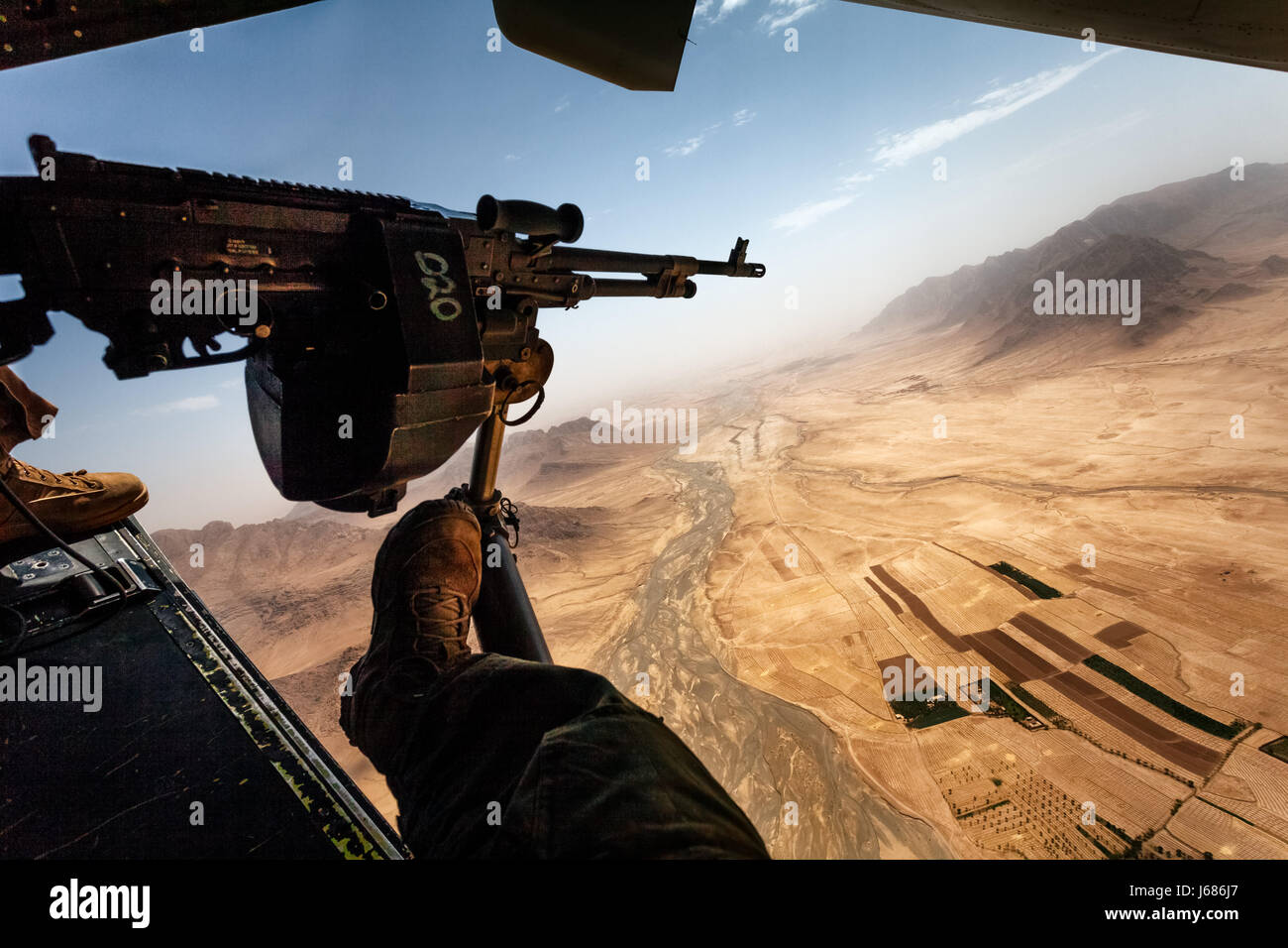 Door Gunners view from the rear of a Bell Boeing V-22 Osprey as it flys to a US Marine Base in Nowzad,  Helmand Province, Afghanistan Stock Photo