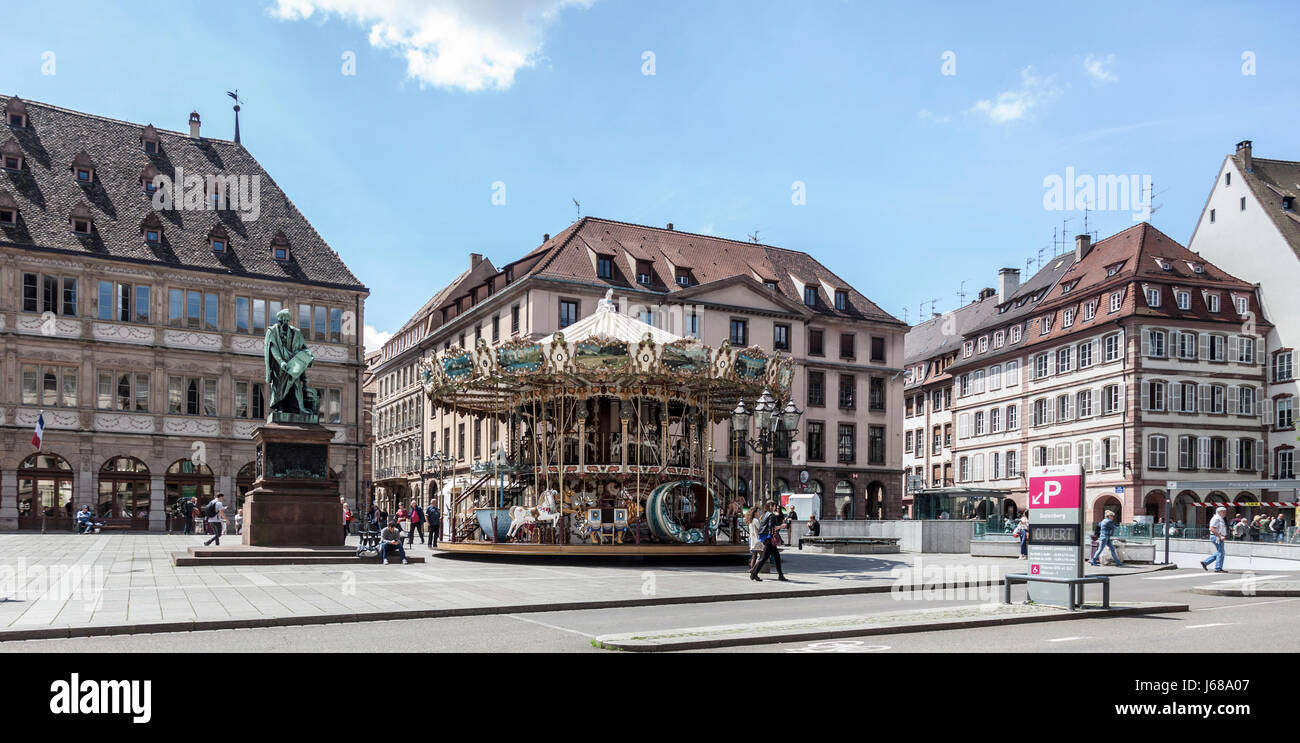 Strasbourg, Place Gutenberg, double-decker carousel, statue of  printer, Johannes Gutenberg, Neue Bau, people, historic, monument historique, france Stock Photo