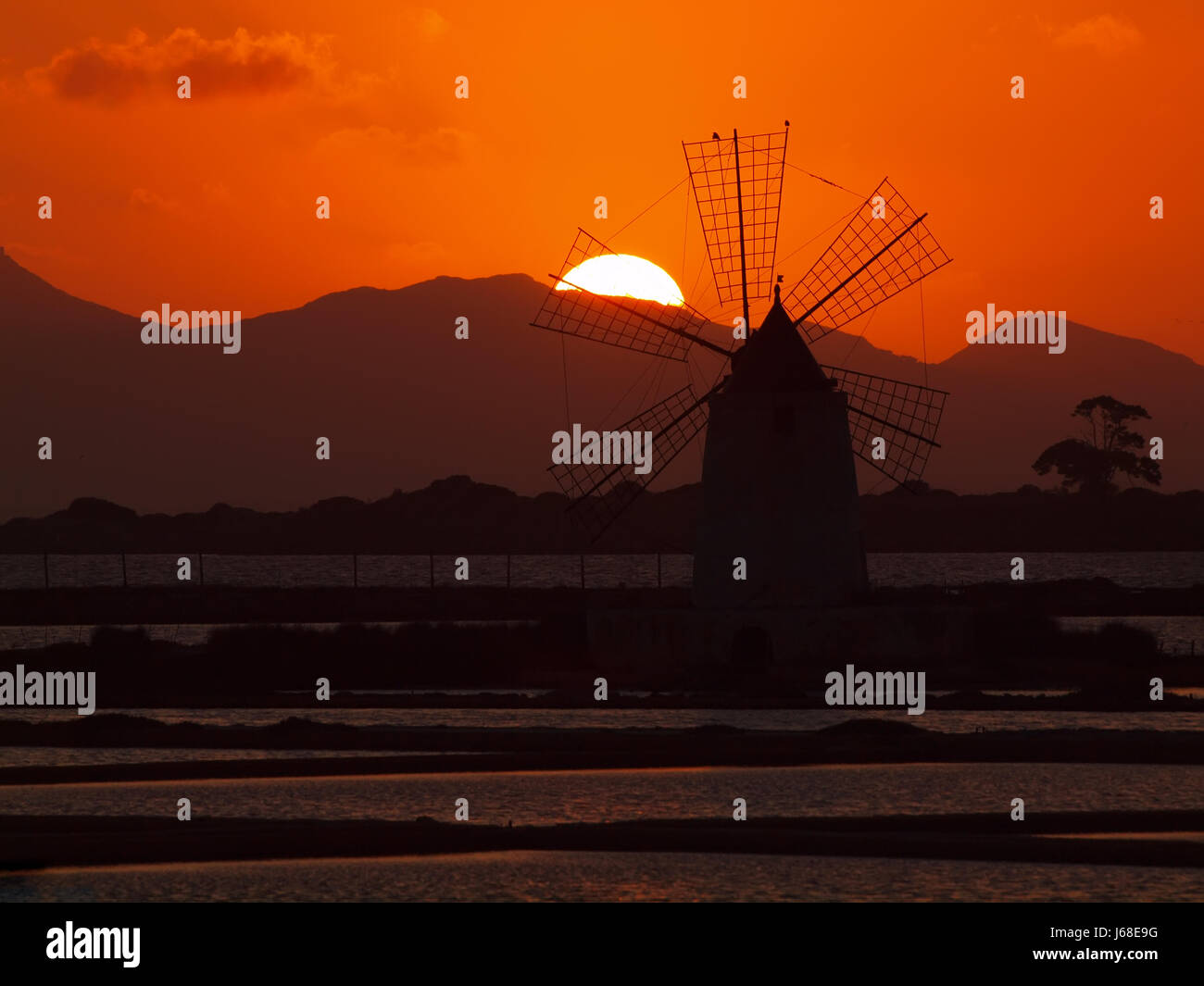sunset windmill sicily saline italy salt horizon sunset mood counter-light Stock Photo