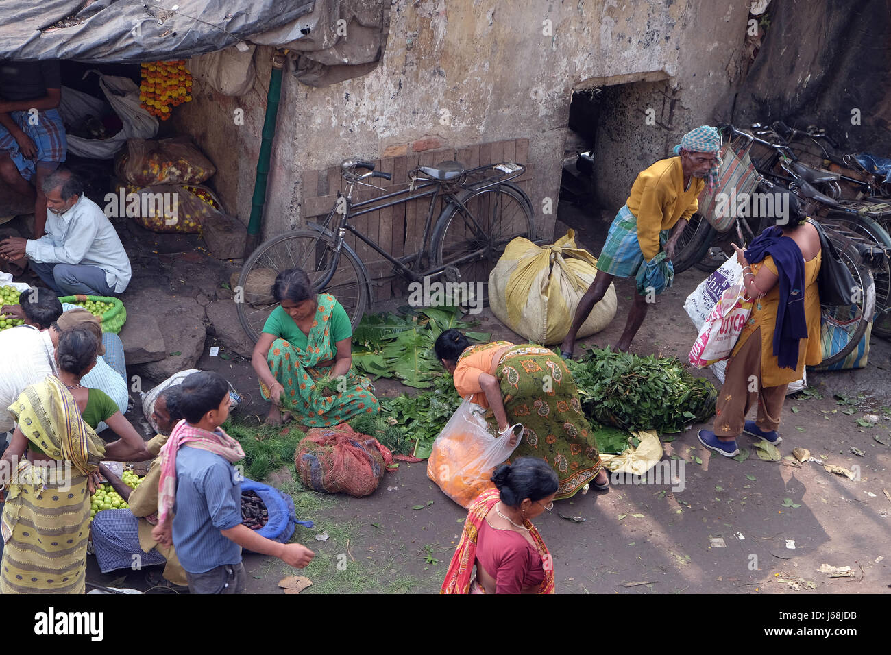 People buying and selling flowers and garlands at the flower market in Kolkata on February 10, 2016. Stock Photo