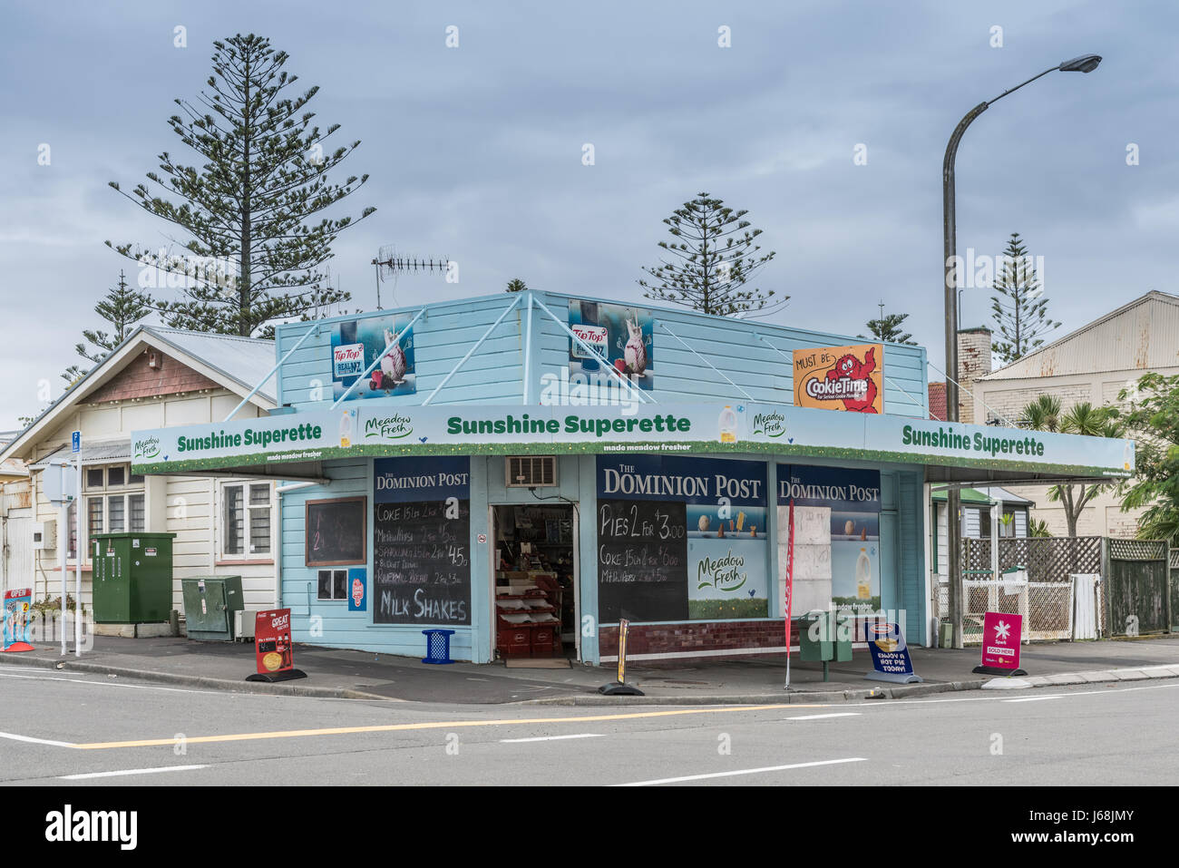 Napier, New Zealand - March 9, 2017: Sunshine Superette is a corner store selling groceries, newspapers and basic household products. Light blue paint Stock Photo