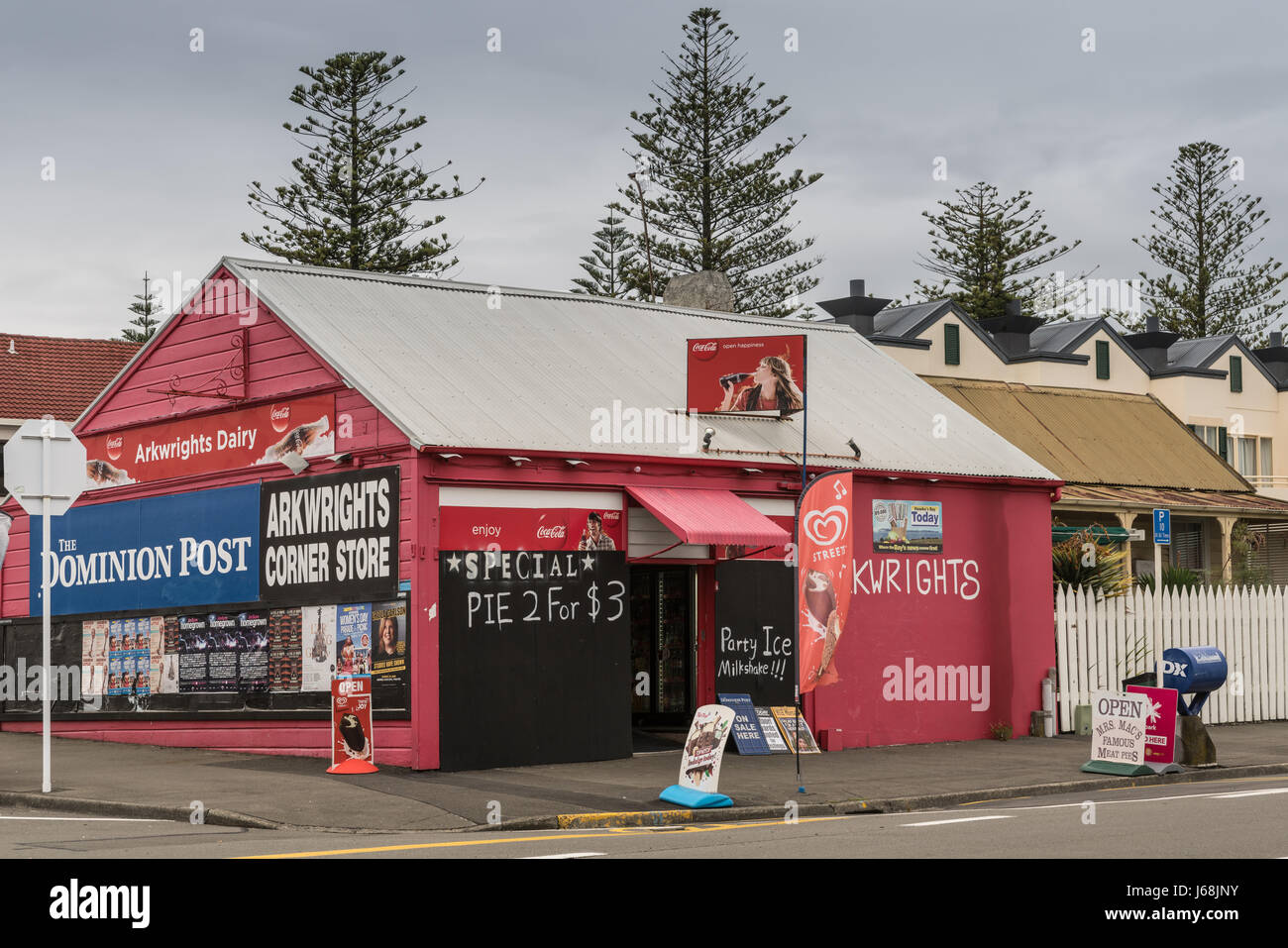 Napier, New Zealand - March 9, 2017: Arkwrights Dairy is a corner store selling groceries, newspapers and basic household products. Red paint, colored Stock Photo