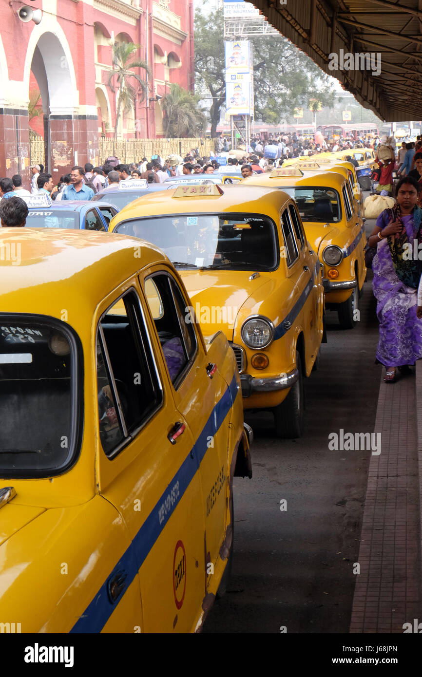 Yellow Kolkata taxis outside Howrah Railway Station in morning rush hour, Howrah, Kolkata, India on February 10, 2016. Stock Photo