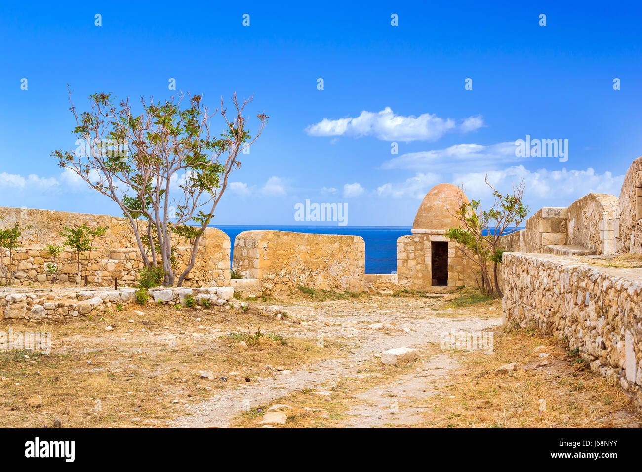 Inner courtyard & fortifications, surrounded by stone walls, Fortezza Castle - Venetian fortress with Bastion defense system on hill Paleokastro in re Stock Photo