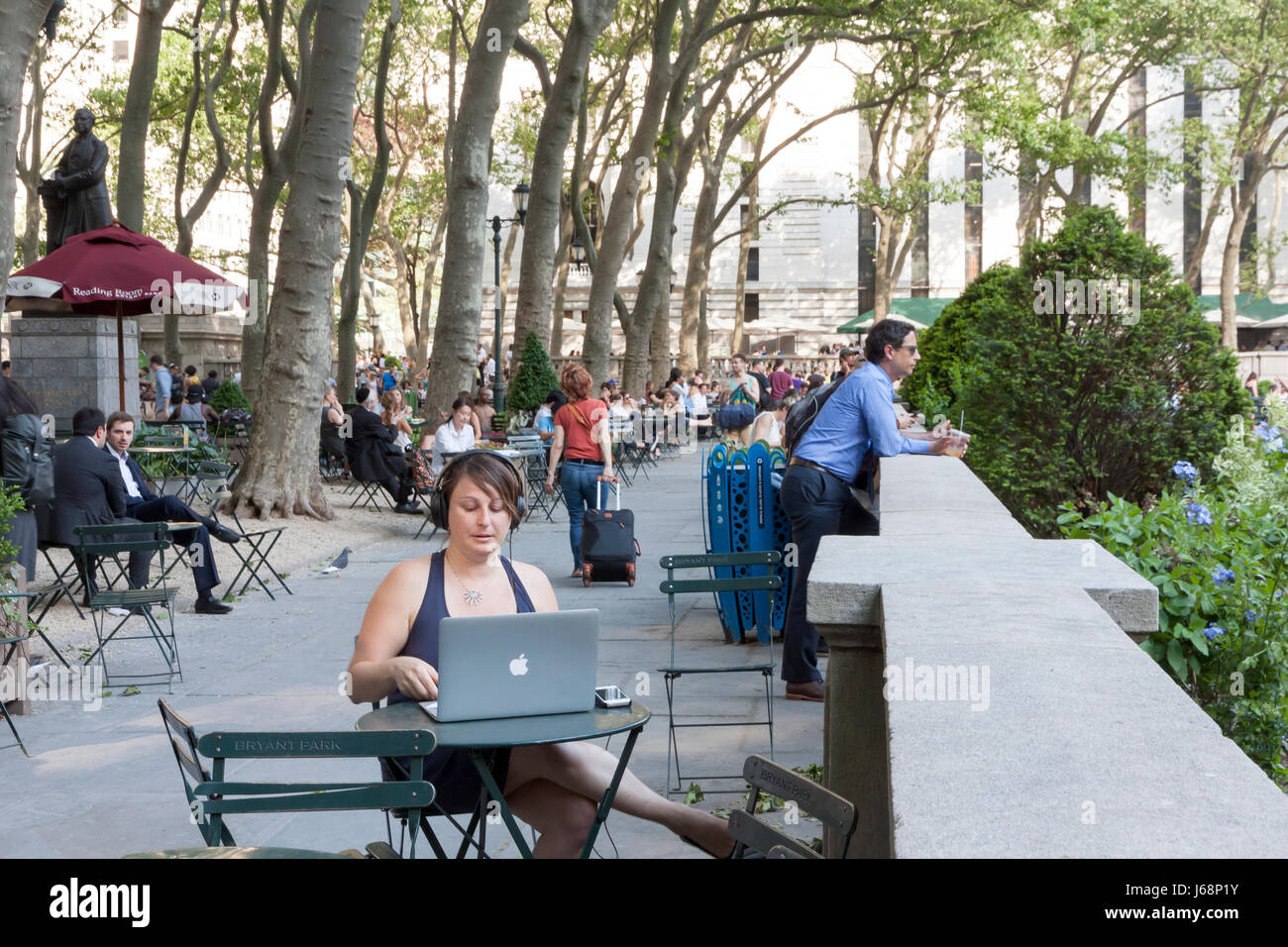 Female on a laptop computer in Bryant Park in midtown Manhattan, New York. Stock Photo