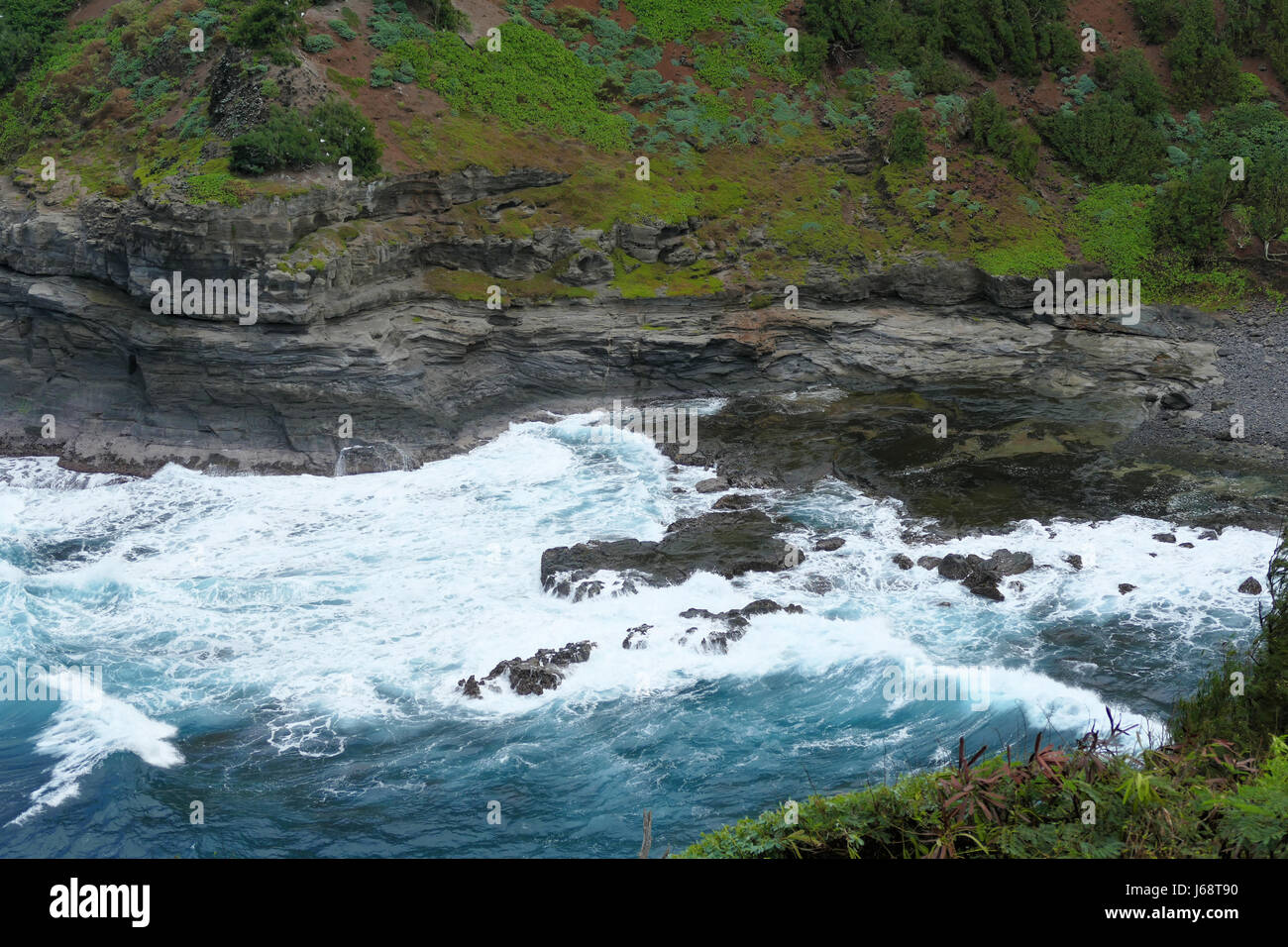 Overcast Stormy Waves Crashing On Rocks By Cliffs Stock Photo