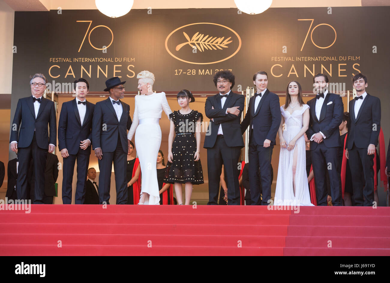 (170519) -- CANNES (FRANCE), May 19, 2017 (Xinhua) -- Actors Byung Heebong, Steven Yeun, Giancarlo Esposito, Tilda Swinton and Ahn Seo-Hyun, director Bong Joon-Ho and actors Paul Dano, Lily Collins, Jake Gyllenhaal and Devon Bostic (From L to R) pose on the red carpet for the screening of the film 'Okja' in competition at the 70th Cannes International Film Festival in Cannes, France, on May 19, 2017. (Xinhua/Xu Jinquan) Stock Photo