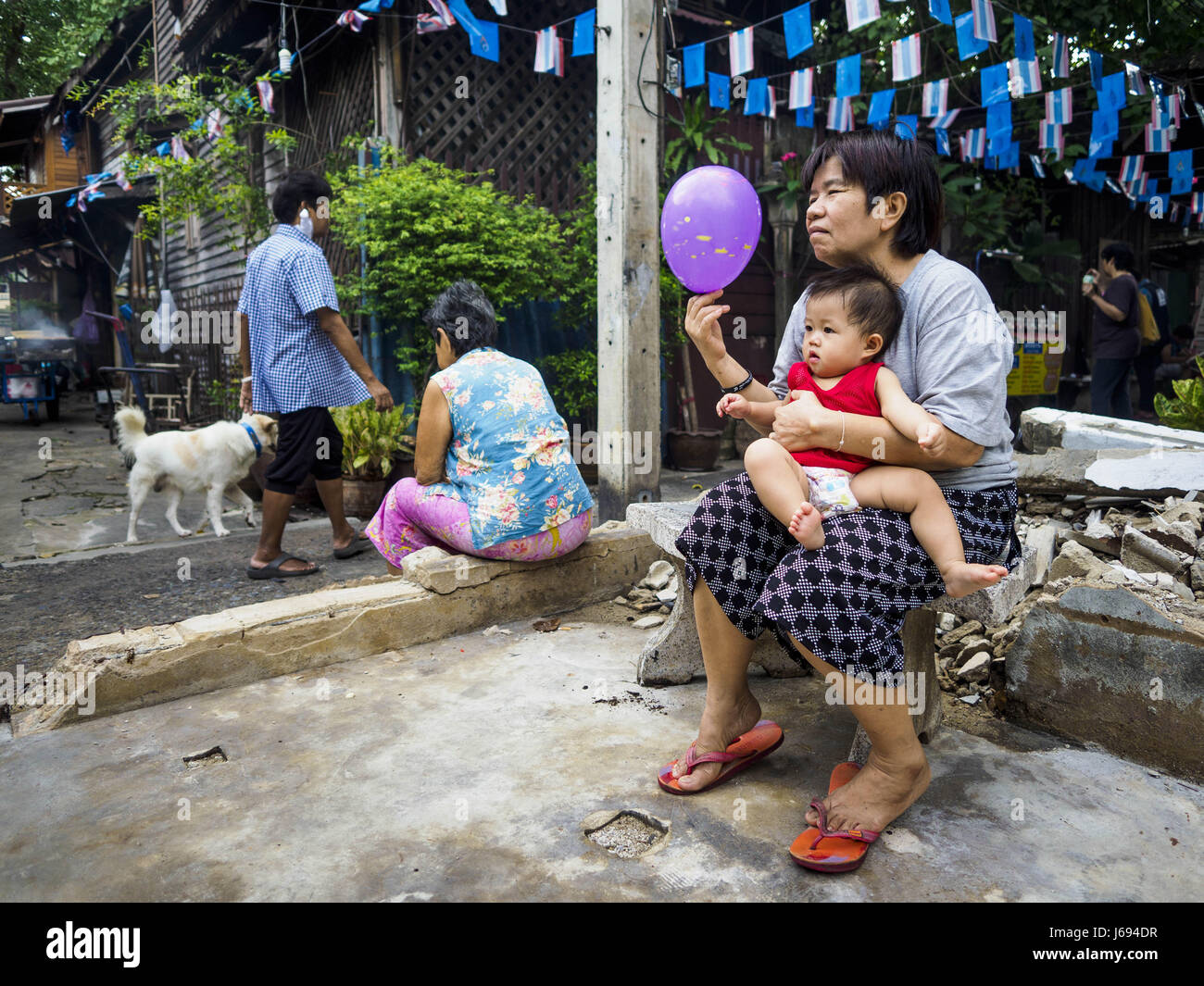 May 16, 2017 - Bangkok, Bangkok, Thailand - A woman and her grandson sit in what used to be a home and is now an empty lot in Pom Mahakan. The city evicted the family living in the home and tore it down. The final evictions of the remaining families in Pom Mahakan, a slum community in a 19th century fort in Bangkok, have started. City officials are moving the residents out of the fort. NGOs and historic preservation organizations protested the city's action but city officials did not relent and started evicting the remaining families in early March. (Credit Image: © Jack Kurtz via ZUMA Wire) Stock Photo