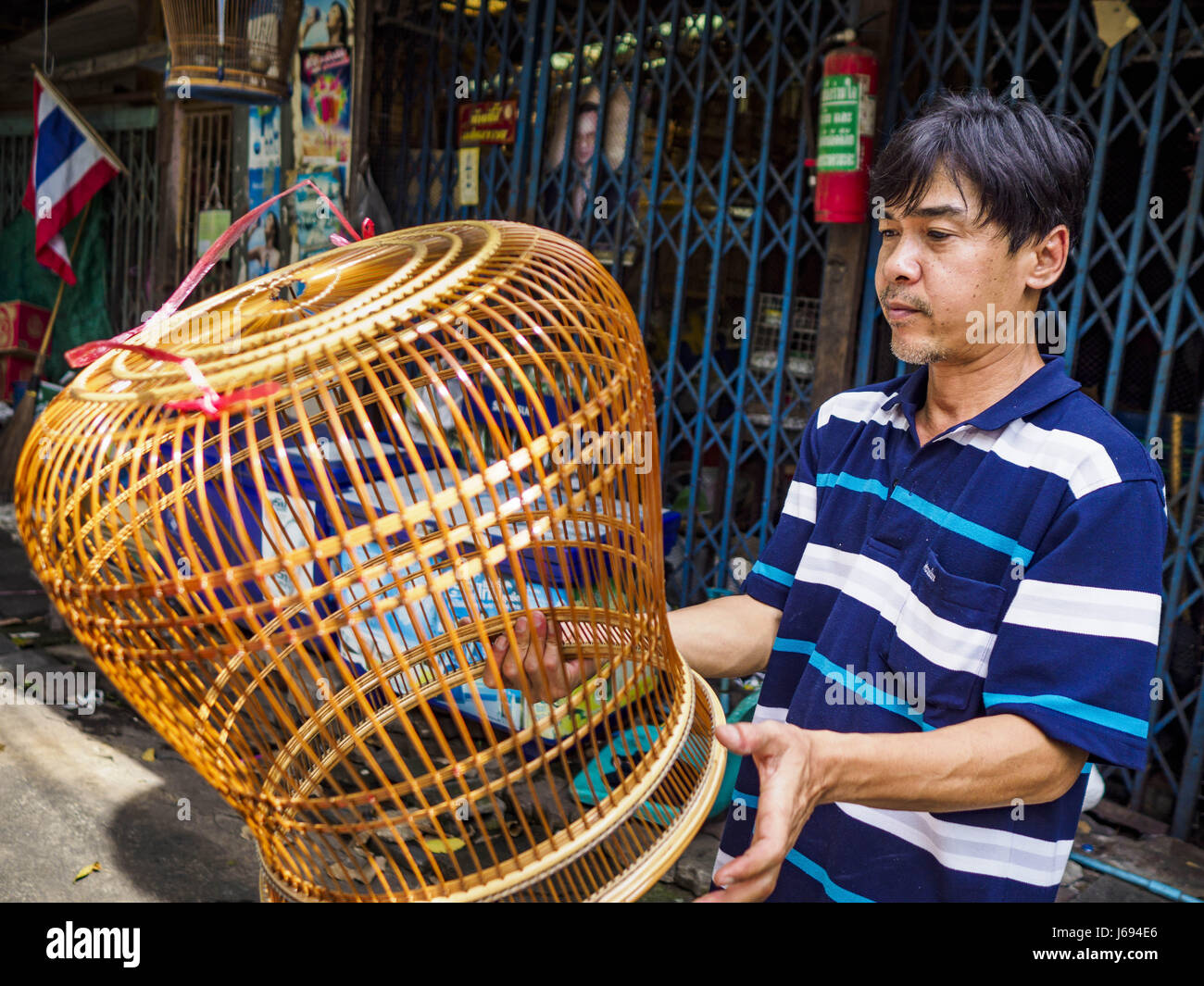 May 16, 2017 - Bangkok, Bangkok, Thailand - SARAYUT NIBLAI, who makes and repairs birdcages, says he is the third generation of his family to live in the Pom Mahakan slum. He is varnishing a bird cage he made in his home workshop. The final evictions of the remaining families in Pom Mahakan, a slum community in a 19th century fort in Bangkok, have started. City officials are moving the residents out of the fort. NGOs and historic preservation organizations protested the city's action but city officials did not relent and started evicting the remaining families in early March. (Credit Image: © Stock Photo
