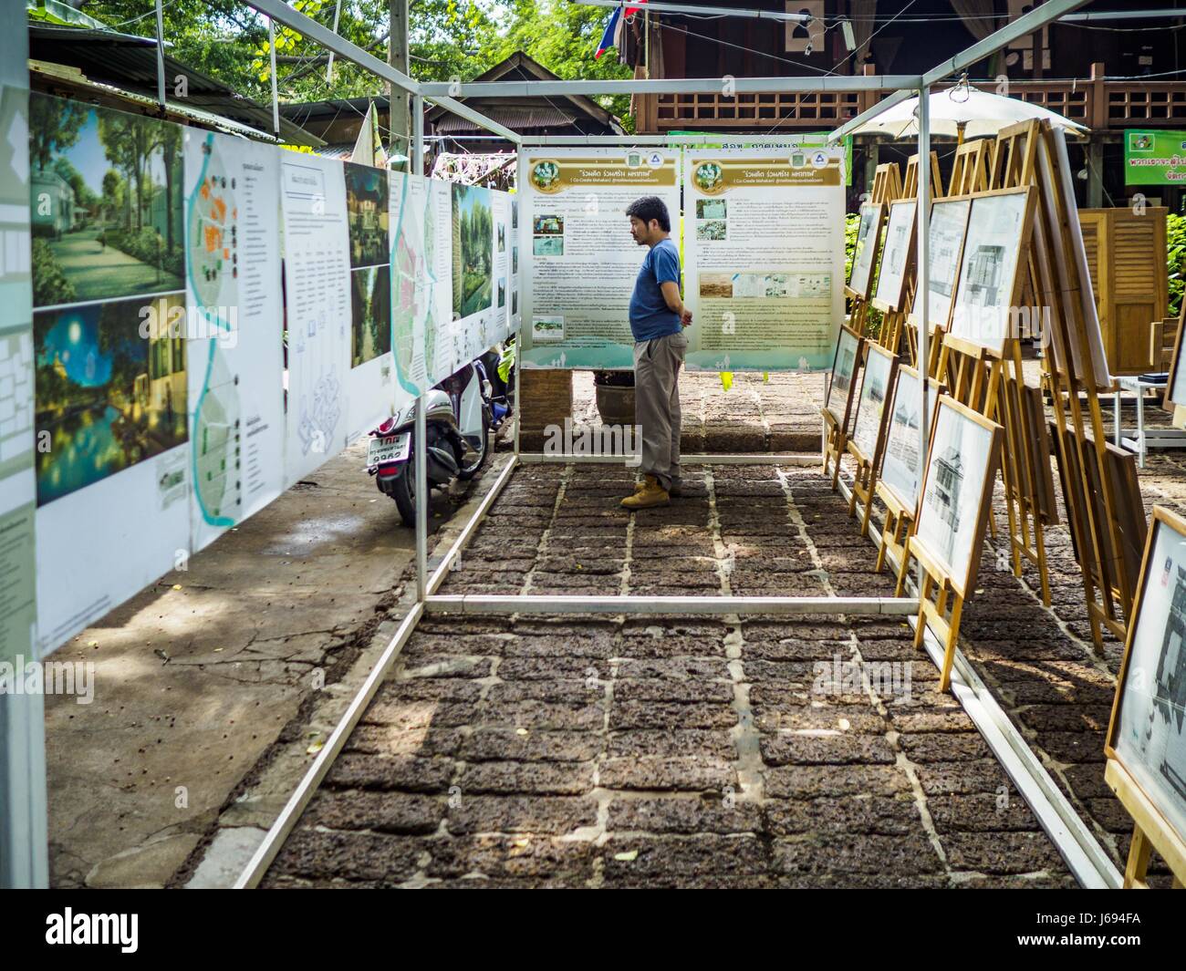 Bangkok, Bangkok, Thailand. 20th May, 2017. A Thai man looks at an exhibit about the historic roots of Pom Mahakan in a community square in Pom Mahakan. The final evictions of the remaining families in Pom Mahakan, a slum community in a 19th century fort in Bangkok, have started. City officials are moving the residents out of the fort. NGOs and historic preservation organizations protested the city's action but city officials did not relent and started evicting the remaining families in early March. Credit: Jack Kurtz/ZUMA Wire/Alamy Live News Stock Photo