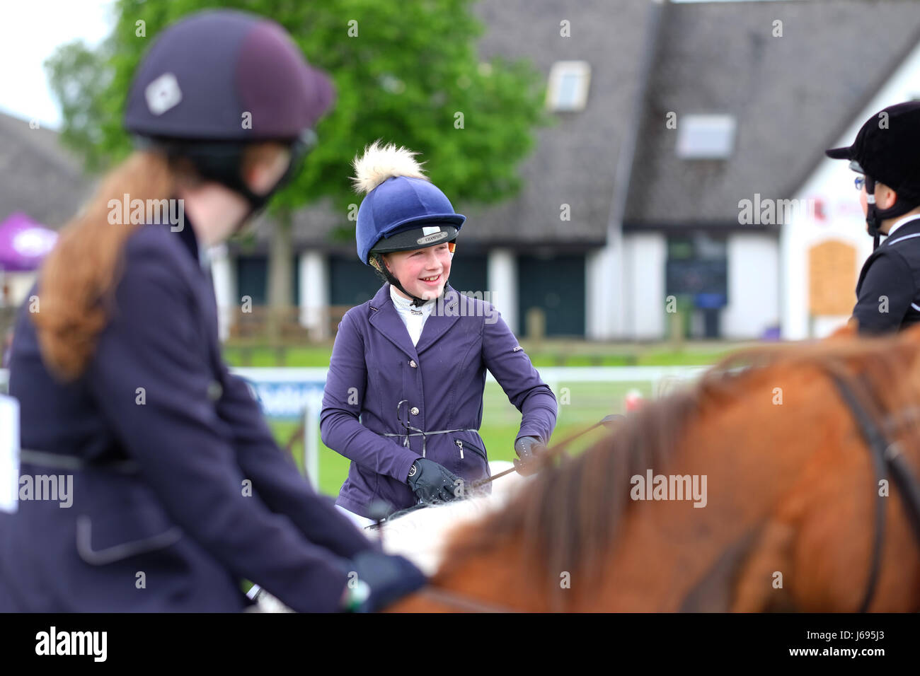 Royal Welsh Spring Festival, Builth Wells, Powys, Wales - May 2017 - Competitors in the junior show jumping event enjoy a laugh whilst waiting their turn to enter the show ring at the Royal Welsh Spring Festival. Credit: Steven May/Alamy Live News Stock Photo