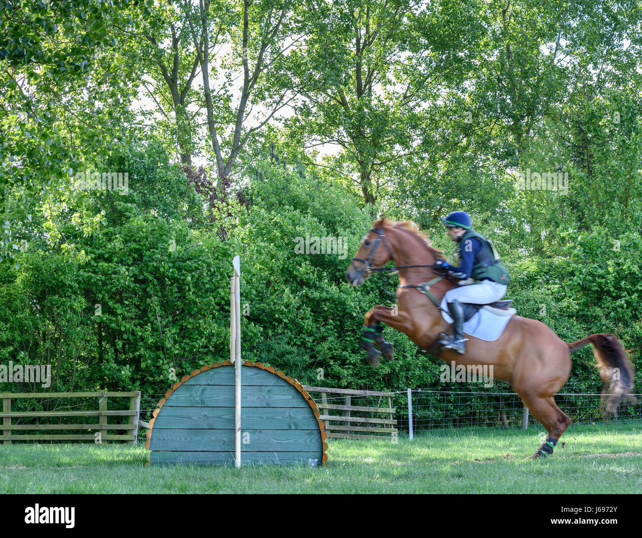 Rockingham Castle grounds, Corby, England. Saturday 20th May 2017. Sam Gillespie and his horse Fernhill leap an obstacle in the cross country phase phase of the Rockingham International Horse Trials on Saturday 20th May 2017 in the grounds of the norman Rockingham castle at Corby, England. Credit: miscellany/Alamy Live News Stock Photo